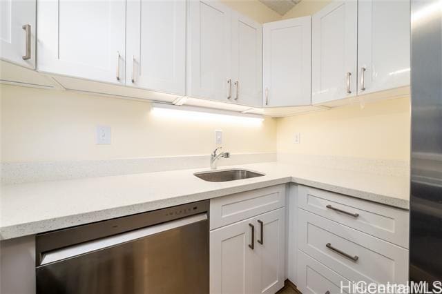 kitchen featuring sink, white cabinets, and appliances with stainless steel finishes