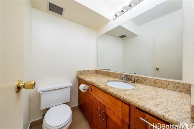 bathroom with vanity and toilet