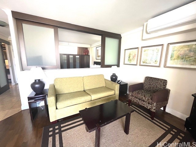 255 Beach Walk Unit 45, Honolulu, HI 96815 - living room featuring ornamental molding, dark hardwood / wood-style flooring, and a wall unit AC