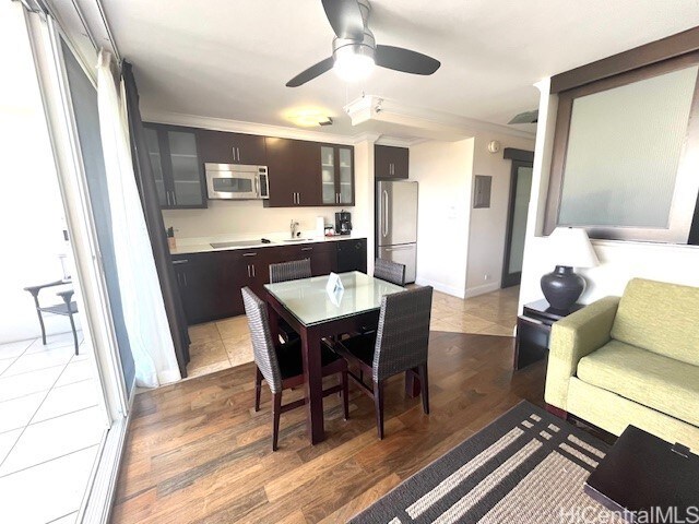 255 Beach Walk Unit 45, Honolulu, HI 96815 - dining area with wood-type flooring, ornamental molding, and ceiling fan