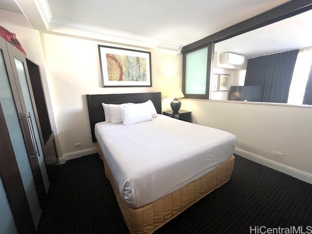 255 Beach Walk Unit 45, Honolulu, HI 96815 - bedroom with dark carpet, crown molding, and a wall mounted AC