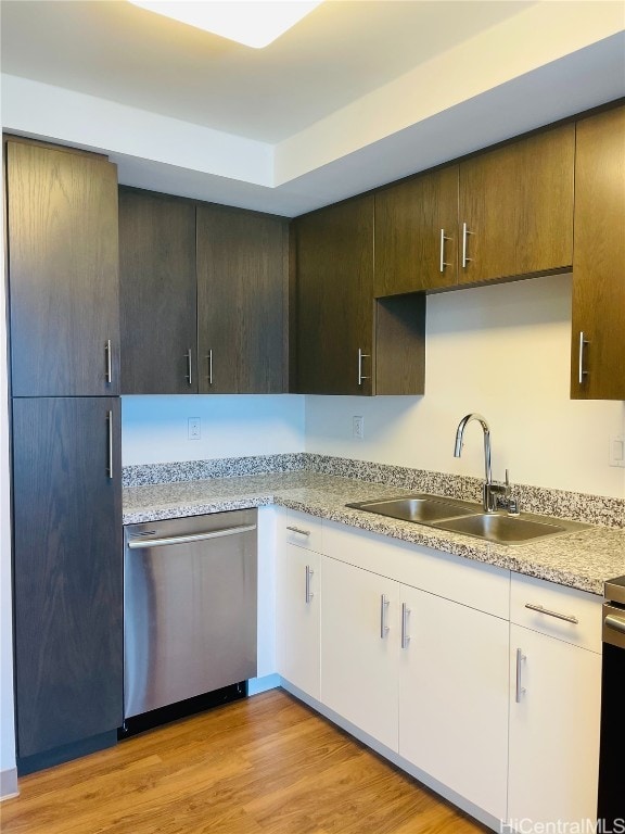 kitchen with sink, white cabinetry, dark brown cabinets, light hardwood / wood-style flooring, and dishwasher