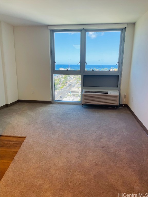 unfurnished room with baseboards and carpet