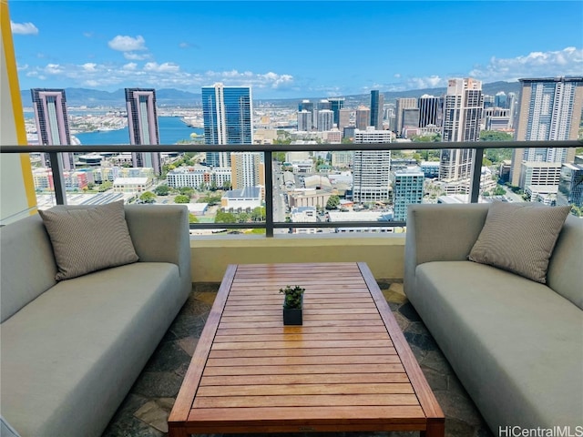 balcony featuring an outdoor living space, a view of city, and a water view