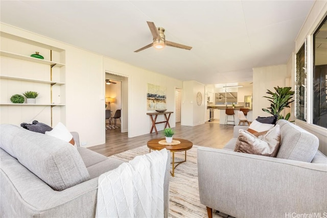 living room featuring ceiling fan and light hardwood / wood-style flooring