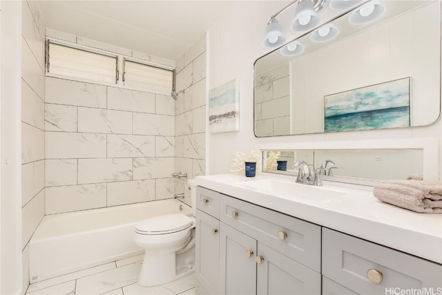 full bathroom with vanity, tiled shower / bath combo, and toilet