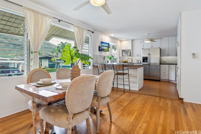 dining space featuring light hardwood / wood-style flooring and ceiling fan