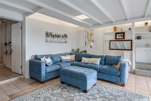 tiled living room featuring brick wall and beam ceiling