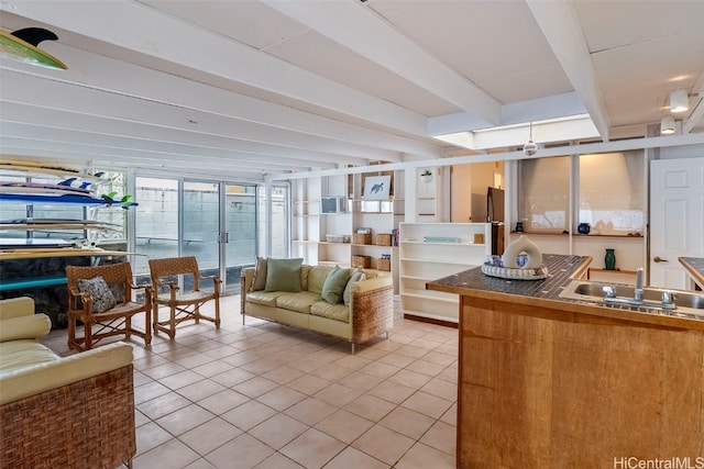 interior space featuring sink and beam ceiling