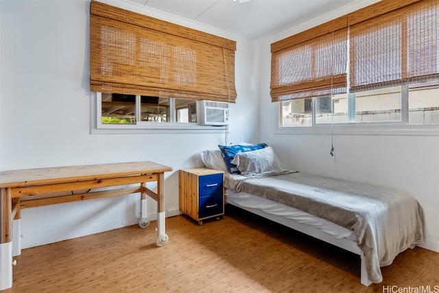 bedroom featuring hardwood / wood-style flooring and cooling unit