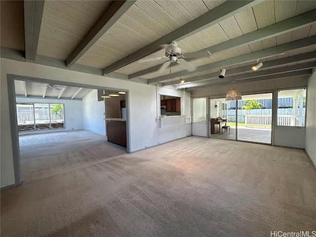 spare room featuring beamed ceiling, carpet flooring, wood ceiling, and ceiling fan