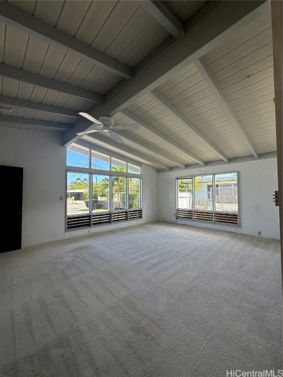 spare room featuring ceiling fan, lofted ceiling with beams, carpet, and wooden ceiling