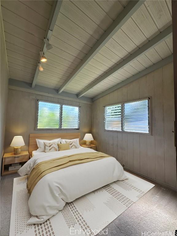 carpeted bedroom with wood ceiling, track lighting, multiple windows, and vaulted ceiling with beams