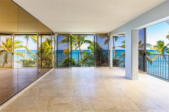 unfurnished sunroom with a water view