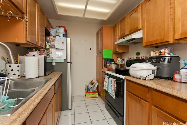 kitchen featuring light tile patterned flooring, sink, electric range, and stainless steel refrigerator