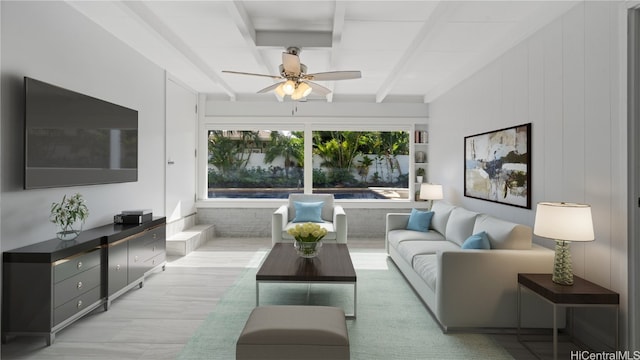 living area with beam ceiling and ceiling fan