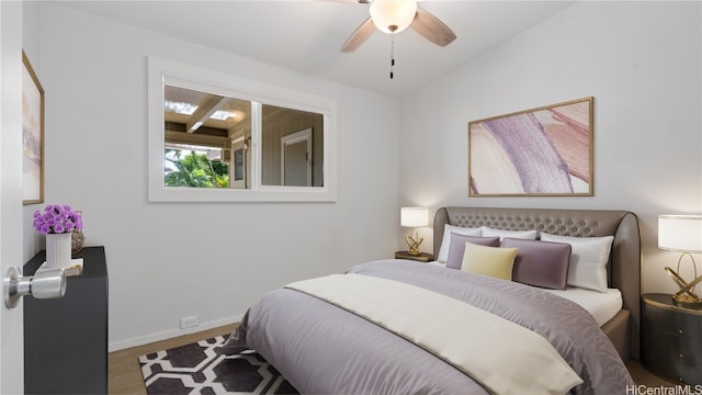 bedroom with baseboards, vaulted ceiling, and wood finished floors