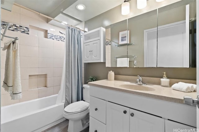 bathroom featuring toilet, shower / bath combination with curtain, and vanity