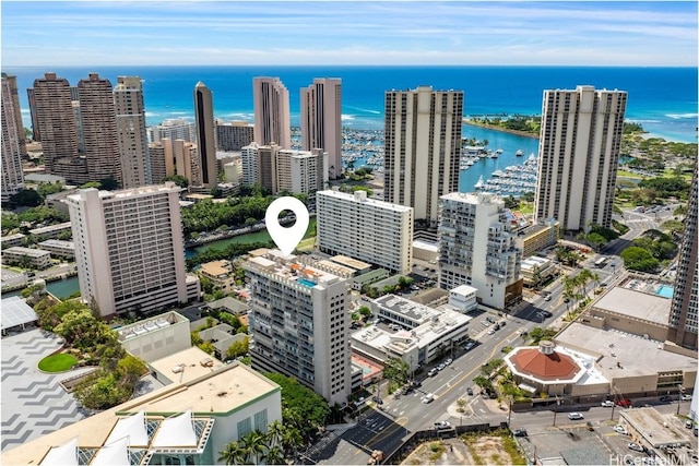 birds eye view of property with a water view and a view of city