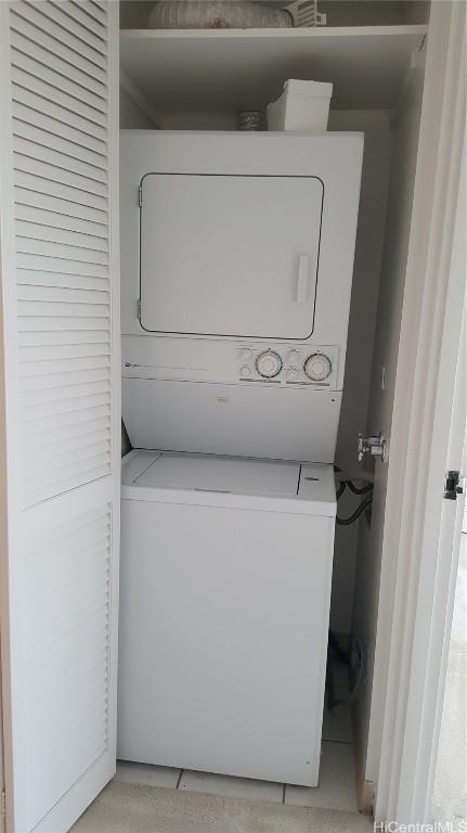 laundry room with stacked washer / dryer