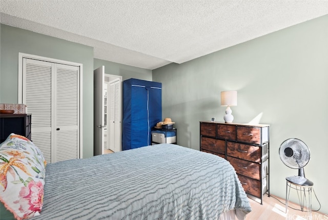 bedroom with a textured ceiling and a closet