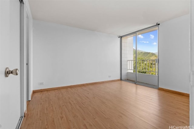 spare room featuring light hardwood / wood-style flooring