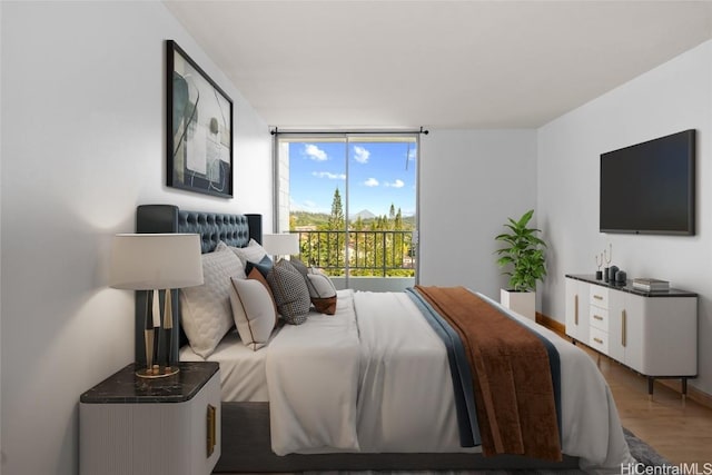 bedroom featuring hardwood / wood-style floors and floor to ceiling windows