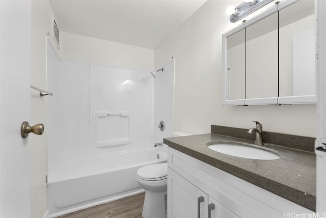 full bathroom with washtub / shower combination, vanity, toilet, and hardwood / wood-style floors