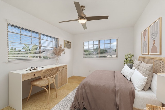 bedroom featuring an AC wall unit and ceiling fan