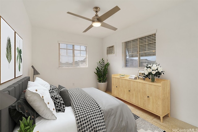 bedroom featuring ceiling fan and a wall unit AC