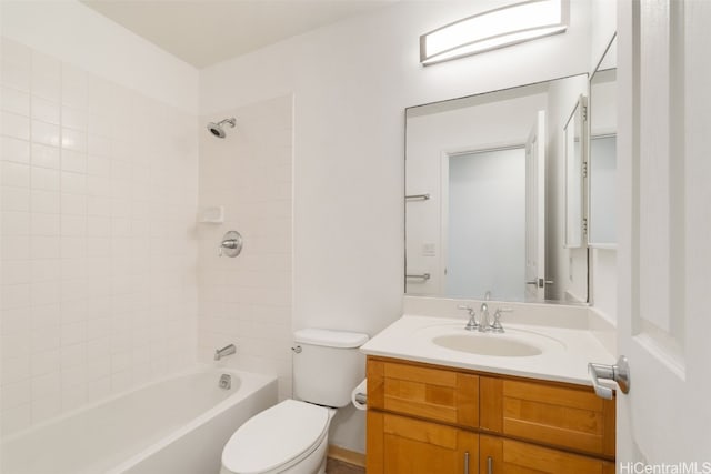 full bathroom with tiled shower / bath, vanity, and toilet