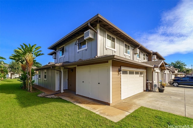 exterior space with a garage, a wall mounted AC, and a front lawn