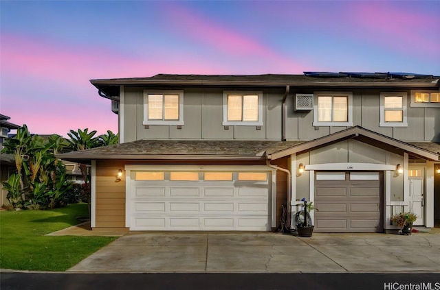 view of front of home featuring a garage and solar panels