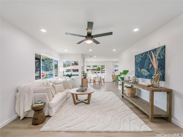 living room featuring light wood-style flooring, a wealth of natural light, and recessed lighting