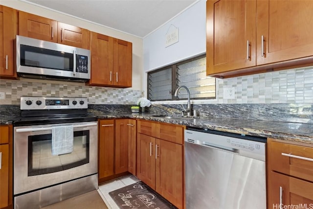 kitchen with sink, decorative backsplash, and appliances with stainless steel finishes