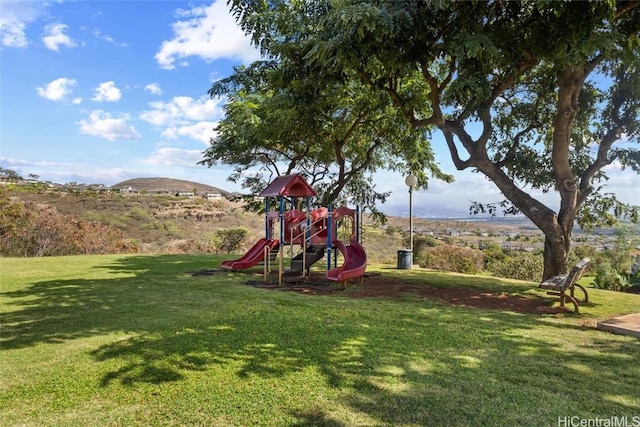 view of jungle gym featuring a yard and a mountain view