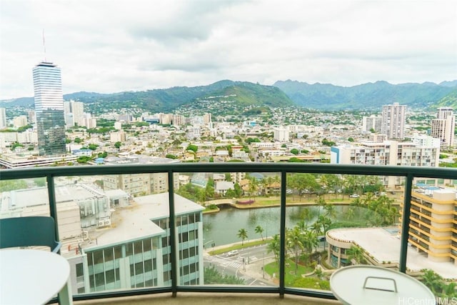 balcony featuring a water and mountain view