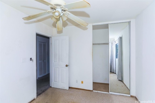 unfurnished bedroom featuring light carpet, ceiling fan, and a closet