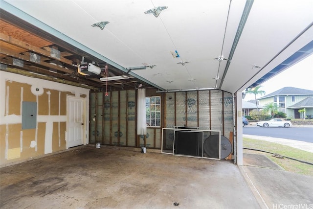 garage with a garage door opener and electric panel