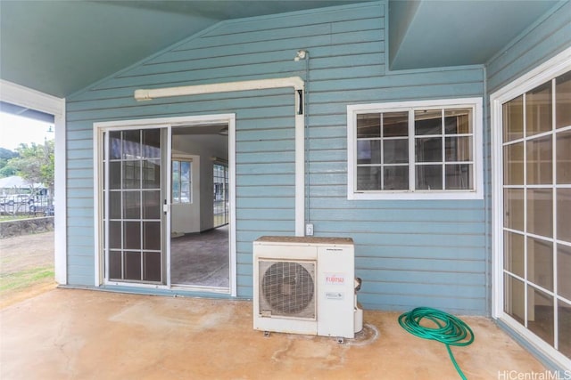 property entrance with ac unit and a patio area