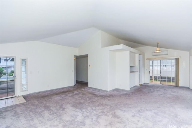 unfurnished living room with vaulted ceiling and light carpet