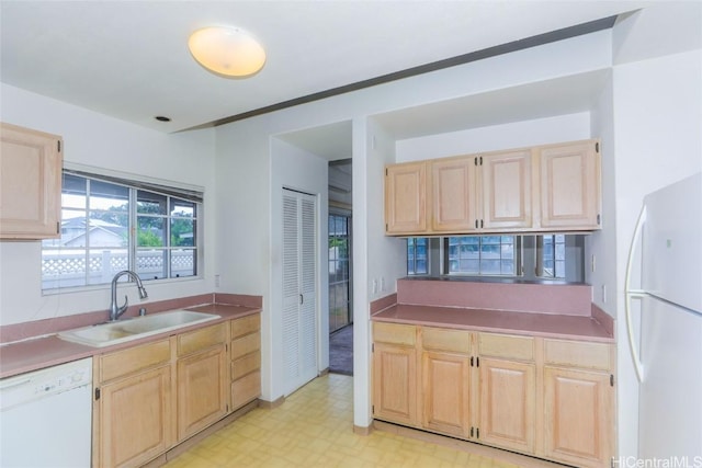 kitchen featuring sink, white appliances, and light brown cabinets