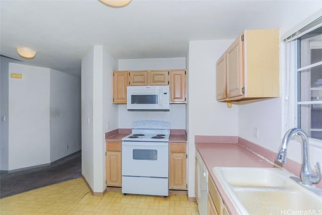 kitchen featuring sink, white appliances, and light brown cabinets