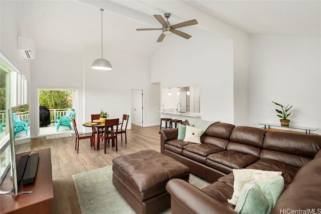 living room featuring ceiling fan, a wall mounted air conditioner, high vaulted ceiling, and light hardwood / wood-style flooring