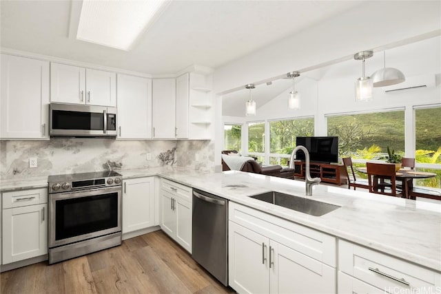 kitchen with stainless steel appliances, white cabinetry, and sink