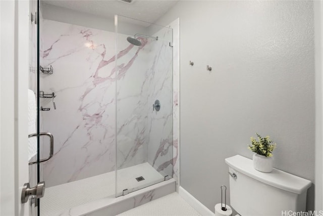 bathroom featuring toilet and an enclosed shower