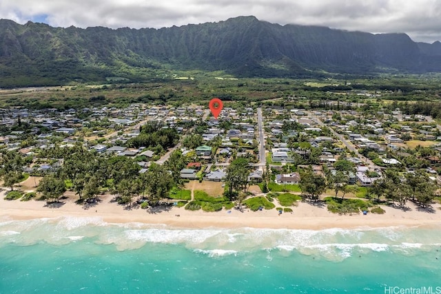 drone / aerial view featuring a view of the beach and a water and mountain view