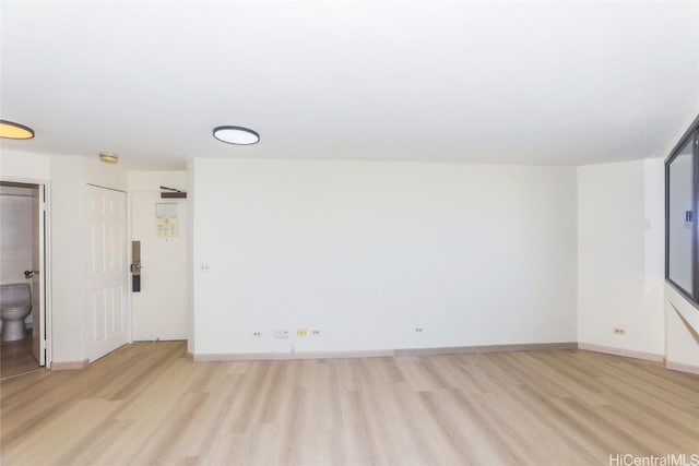 spare room featuring light hardwood / wood-style floors