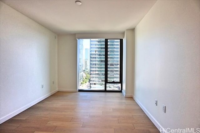 empty room with light hardwood / wood-style floors