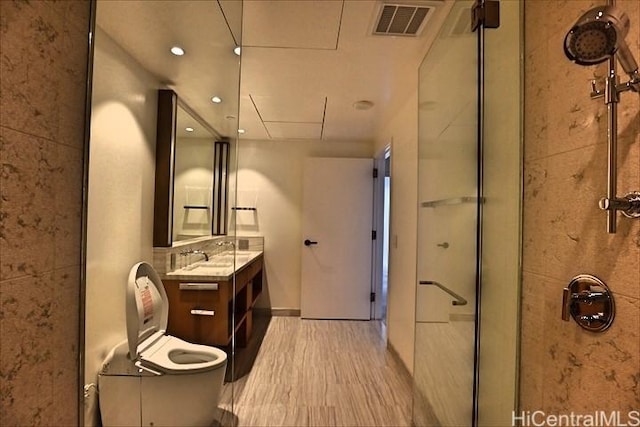 bathroom featuring vanity, toilet, and walk in shower